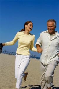 Middle-aged Couple Running on the Beach